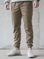 spodnie-materialowe-jogger-laur-icon-bezowe-biale (1).jpg