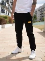 spodnie-dresowe-meskie-czarne-zolte-jigga-wear-name-patch_7.webp
